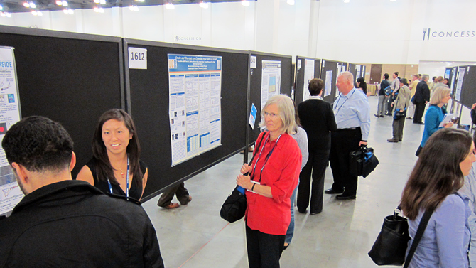 Poster presenters engaging in discussions with summit participants